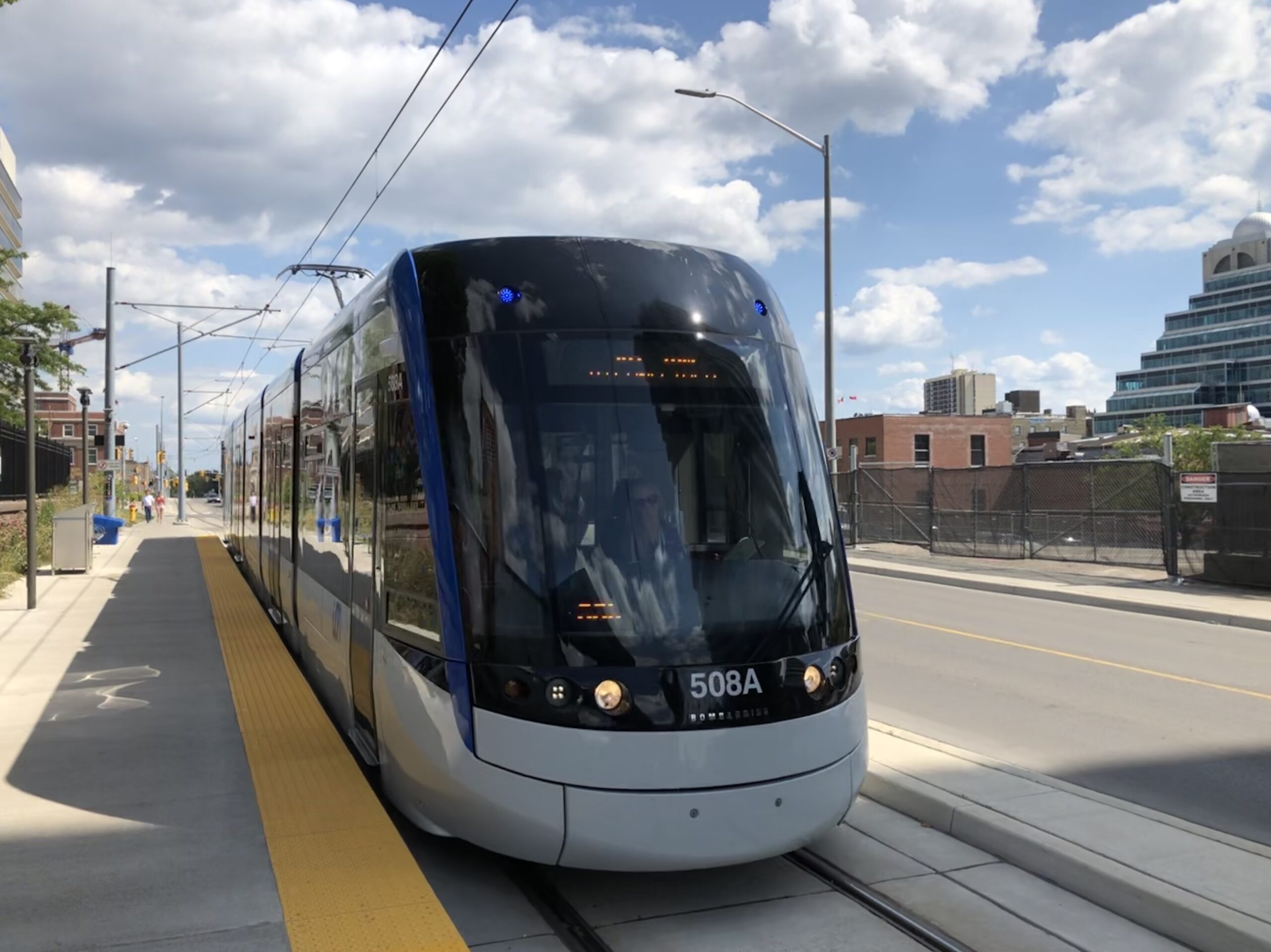 An ION Light Rail Transit train arrives at a station in Kitchener